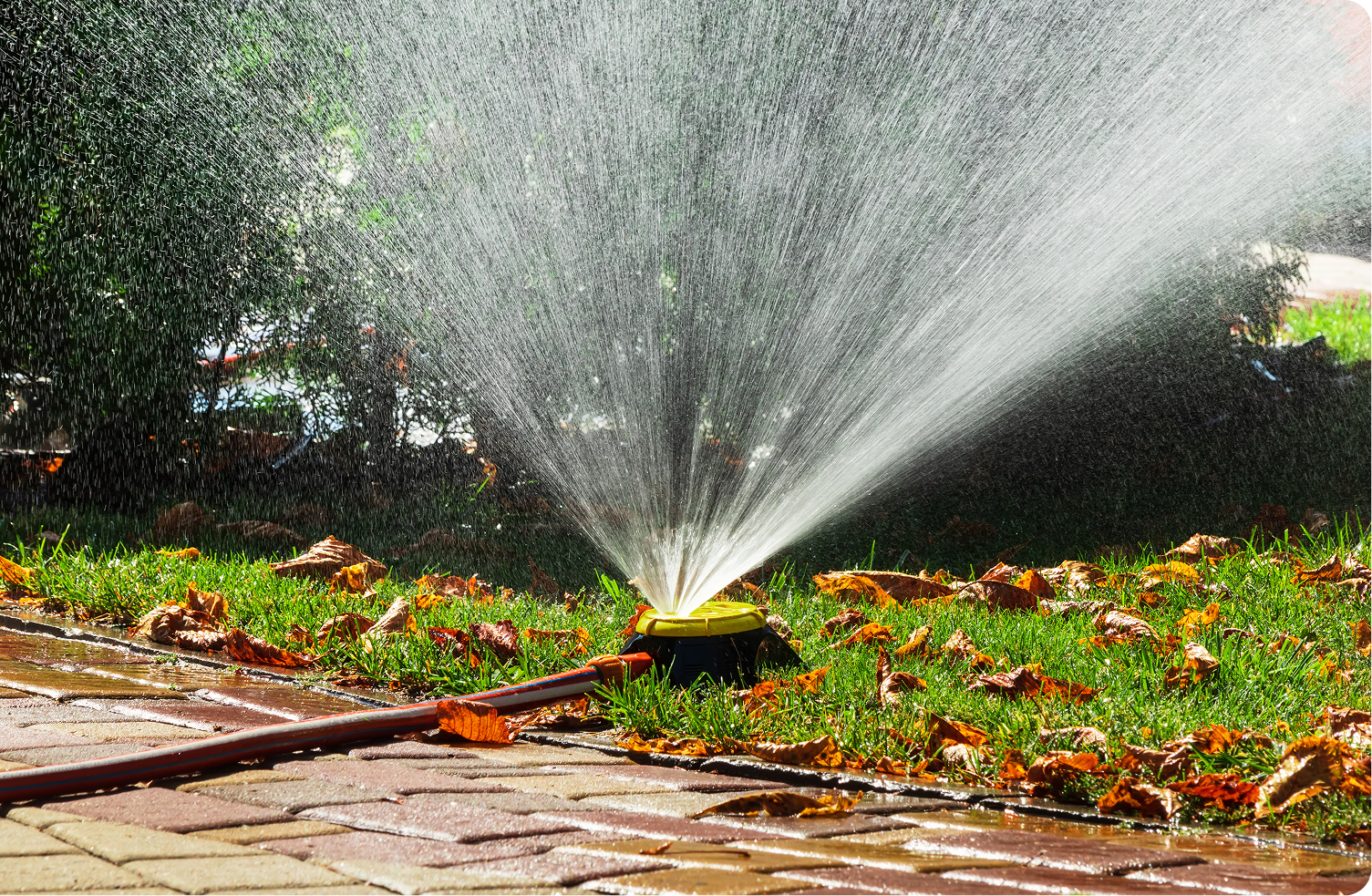 Lawn sprinkler spraying water in garden