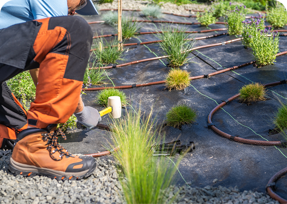 Man using mallet in landscaping project